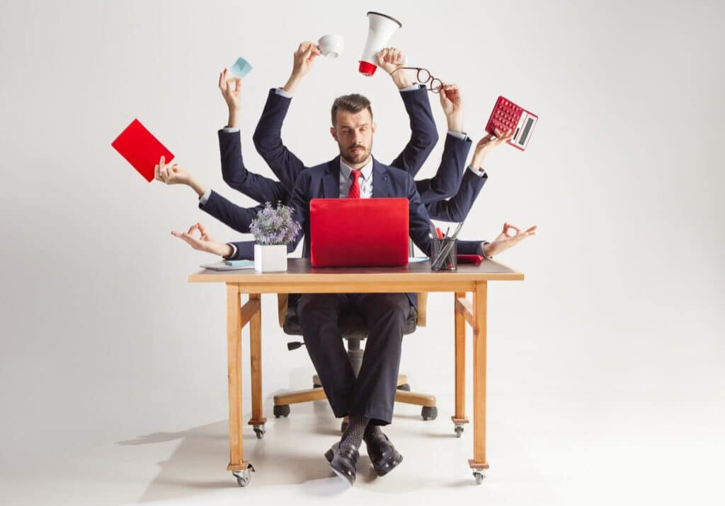 businessman with many hands in elegant suit working and holding office tools. Isolated over white background. Concept of busy