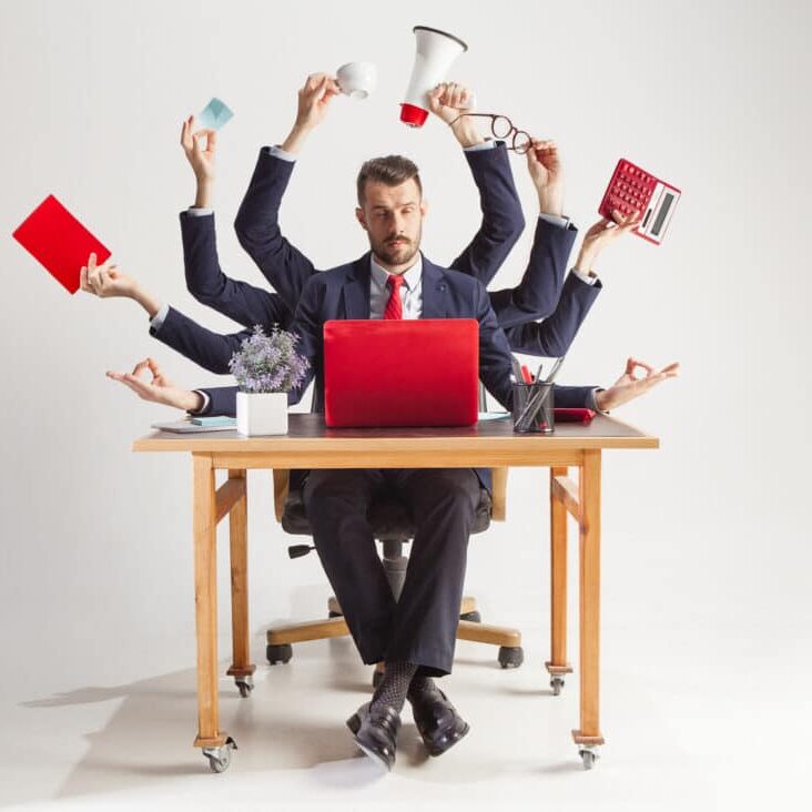 businessman with many hands in elegant suit working with paper, document, contract, folder, business plan. businessman with many hands in elegant suit working and holding office tools. Isolated over white background. Concept of busy