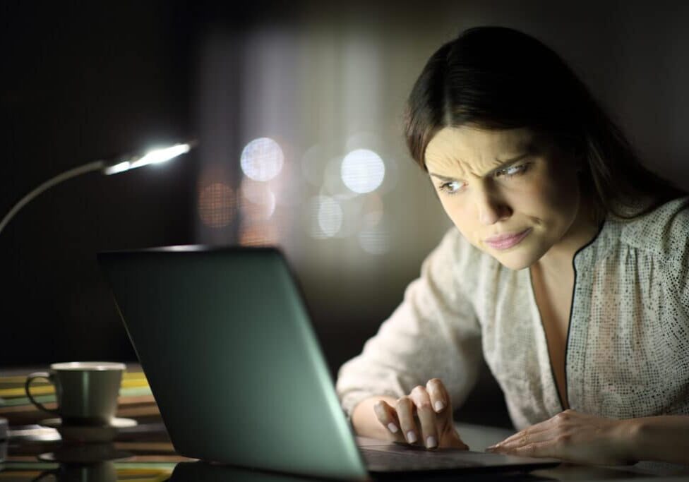 Suspicious woman checking laptop content in the night