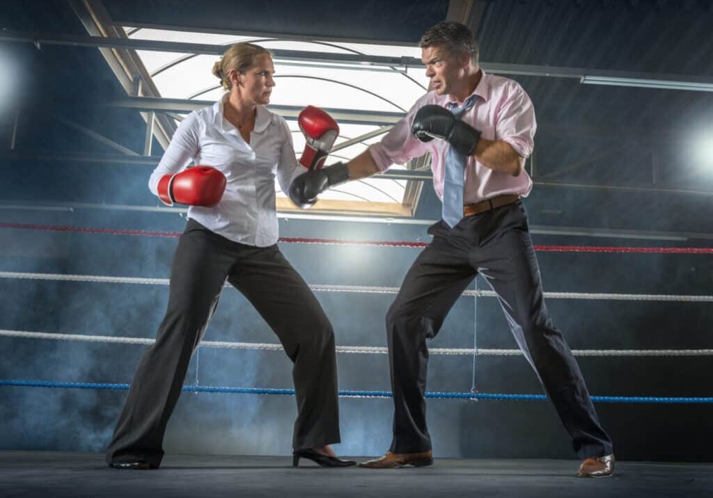 Business couple fighting in smokey boxing ring Couple woman punching boxing a man dispute conflict