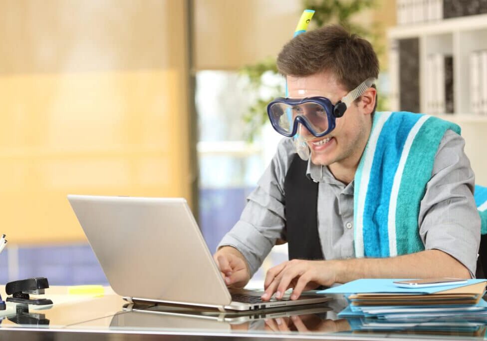 Businessman working needing vacations Businessman working on line or searching travel destinations with goggles needing vacations at office