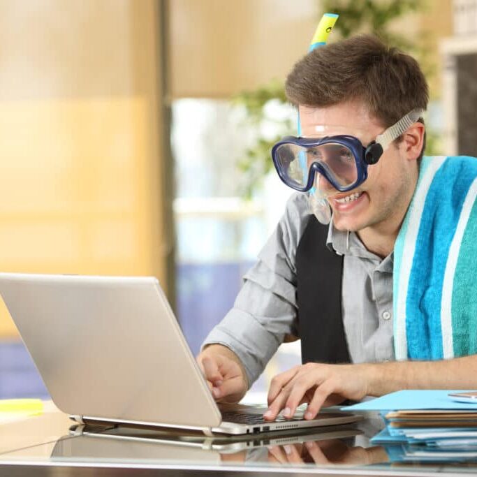 Businessman working on line or searching travel destinations with goggles needing vacations at office